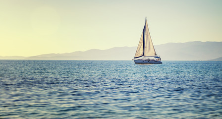  Sailing yacht in Mediterranean sea at sunset. Travel and active lifestyle concept