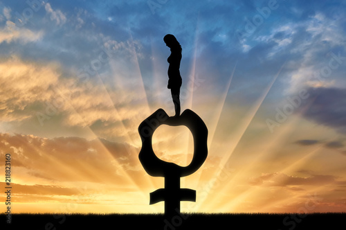 Fotografia, Obraz Silhouette of a sad woman standing on a female gender symbol that became flabby