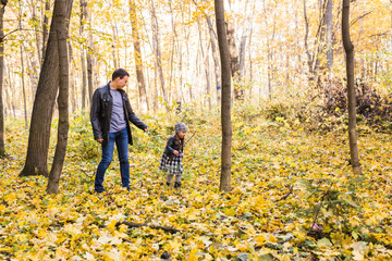 Family, autumn, people concept - father and daughter walking in autumn park