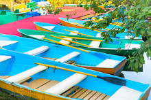 Row Of Many Empty Colorful Boats At Pier