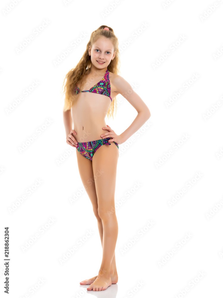 A little girl in a bathing suit in full growth. Stock Adobe Stock