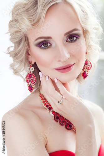 Portrait Of Young Adult Blonde Model With Wavy Hair Jewelry Red