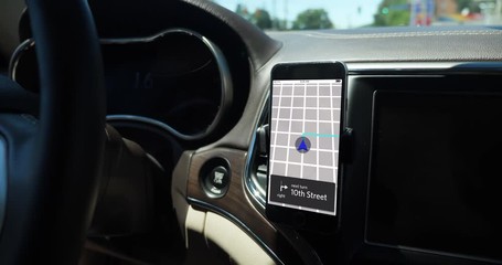 A smartphone attached to the dash on a vent holder in a moving car shows a ride sharing app with route in progress. App screen simulated.	