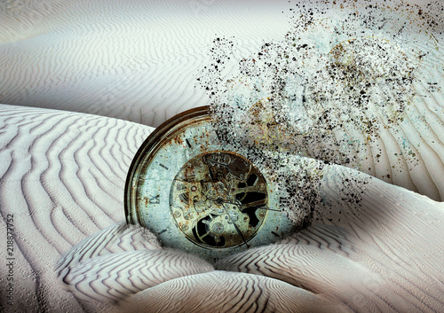 Fotografía antique disintegrating clock buried in desert sand