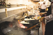 Chef stirring in wok