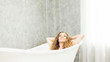 © pic for you - Young woman relaxing in bath.beautiful woman lying in bathtub.