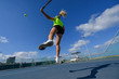 © PROMA - Girl playing tennis on a court