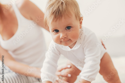 Fototapeta Young mom with her 8 month baby