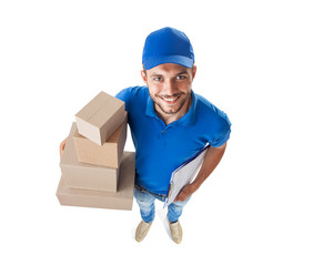 Canvas Print - Funny courier with boxes looking at camera isolated on white background