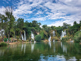 Fototapeta Sawanna - Beautiful waterfall and green forest in Kravica, Bosnia