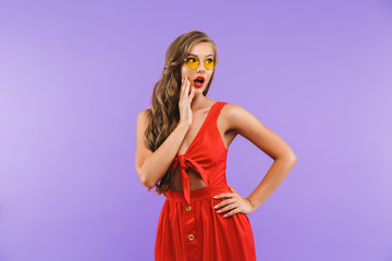 Portrait of a shocked young woman in red dress