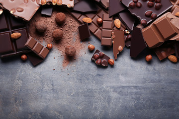 Poster - Chocolate pieces with nuts on grey wooden table