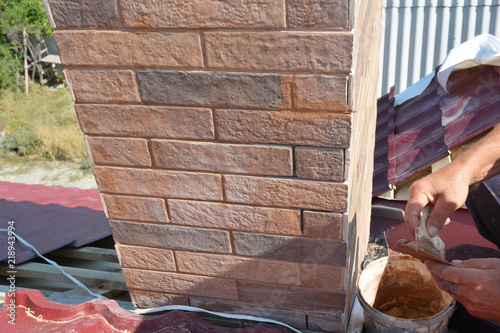 Cuadros en Lienzo Installing house chimney blocks on the rooftop