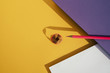 © ADDICTIVE STOCK - Back to school: Pink pencil on geometric background