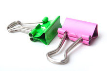 Closeup Of Pink And Green Paperclips On White Background