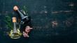 Olive oil and soy sauce in glass jars. Spices and Sauce. Top view. On a black wooden background. Free space for text.