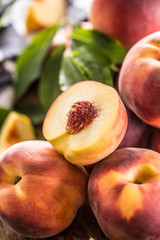 Wall Mural - A group a ripe peaches on wooden table