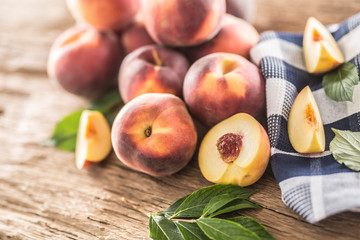 A group a ripe peaches on wooden table