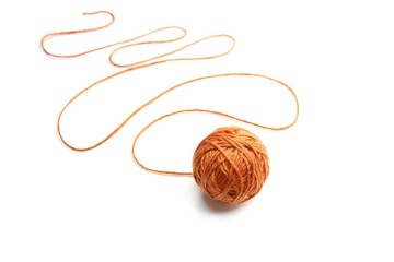 Wall Mural - orange thread ball with serpentine thread isolated on white background. cotton thread ball.