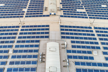 Aerial top down view on many Solar panels rows lined up on of factory roof