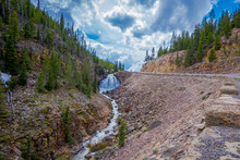 Outdoor View Of The Small Falls, Located At One Side Of The Road To Arrive To The Yellowstone National Park, In A Beautiful Sunny Day And Blue Sky In Wyoming