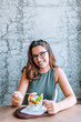 © bnenin - Cute brunette woman eating fruit salad.