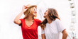 © chichkaua - Best friend having fun near Ferris wheel, going crazy together, wearing hats and mirrored sunglasses, amazing view on the city, bright colors evening sunlight