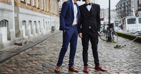 stylish gay couple holding hands. homosexual wedding.