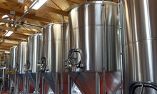 Row Of Shiny Metal Micro Brewery Tanks.