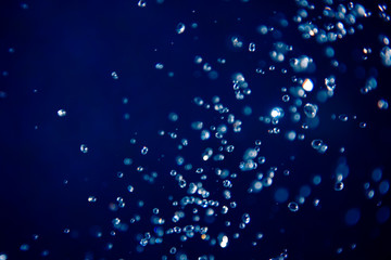 defocus bokeh of water drop on blue