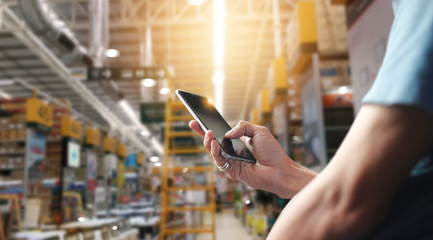 Poster - Factory worker using application on mobile smartphone to operate automation for modern trade. Checking order in large warehouse. Import and export the shipping cargo.