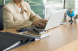 © Golden House Images - Business woman working with laptop at business office. Selective focus.