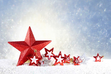 Poster - Beautiful colorful Christmas composition in light tones of red Christmas stars different sizes on a sparkling light blue background, copy space.