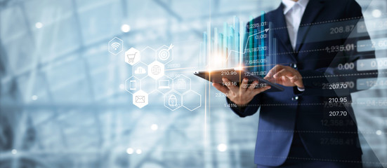 Leinwandbilder - Businessman using tablet analyzing sales data and economic growth graph chart.  Business strategy. Abstract icon. Digital marketing.