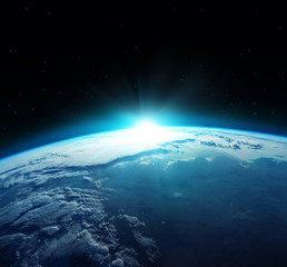 Wall Mural - view of blue planet earth with sun rising from space.