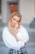 © Михаил Решетников - portrait of a blonde on a building background with columns. beautiful blonde in a white blouse smiling