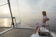 © Westend61 - Mature woman on catamaran, watching sunset