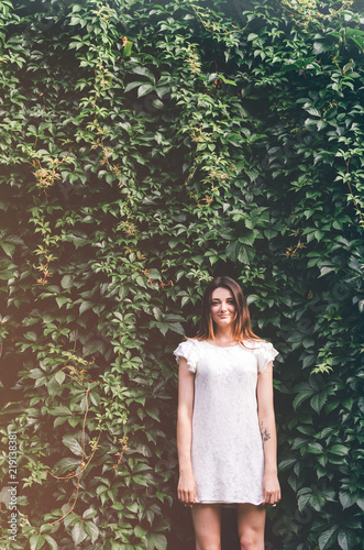 Fotografie, Obraz Beautiful young woman in wild leaves (grapes)