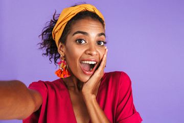 Poster - Cheerful african woman in dress having fun and making selfie