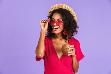 Poster - Cheerful african woman in dress, straw hat and sunglasses