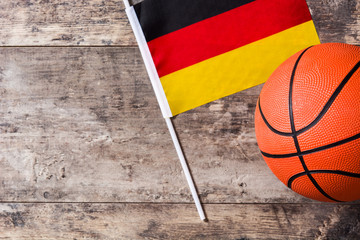 Basketball and German flag on wooden table. Top view. Copyspace