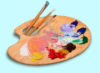 Wall Mural - Wooden art palette with blobs of paint and a brushes on white