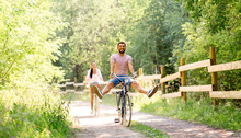 Cycling, Leisure And Lifestyle Concept - Happy Young Couple With Bicycles At Summer Park