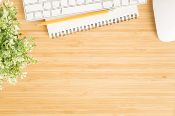 Wall Mural - flat lay photo of office desk with mouse and keyboard ,top view workpace on bamboo wood table and co