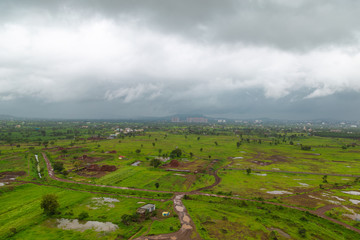 Poster -  Awesome arial countryside landscape view. A beautiful monsoon day. Low hanging clouds touching the distant mountain/hill. 