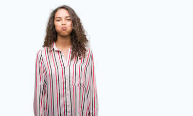 Canvas Print - Beautiful young hispanic woman puffing cheeks with funny face. Mouth inflated with air, crazy expression.