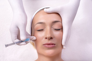 Portrait of beautiful woman during anti aging treatment with hyaluronic acid