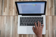 © JD8 - Top view male hands using Laptop sitting on a wooden floor