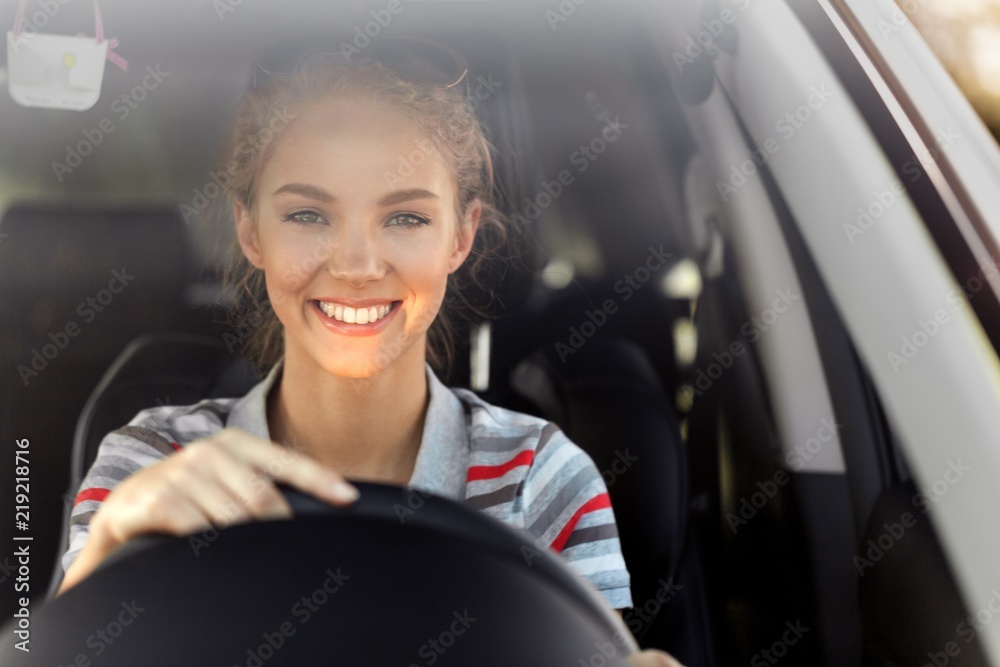 Portrait of Smiling Young Woman Driving her Car - obrazy, fototapety, plakaty 
