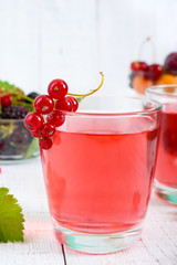 Wall Mural - Refreshing drink compote of summer berries in glasses on a white wooden background.